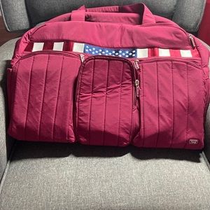 Lug overnight/gym duffel zip bag in maroon, 20” long x 14” tall and 9.5 wide.